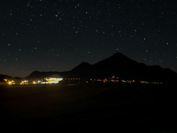 Illuminated city against sky at night