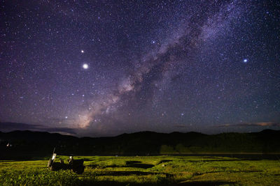 Scenic view of field against sky at night