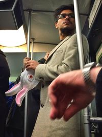 Mid adult man standing in bus