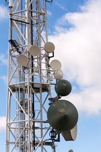 Low angle view of communications tower against sky