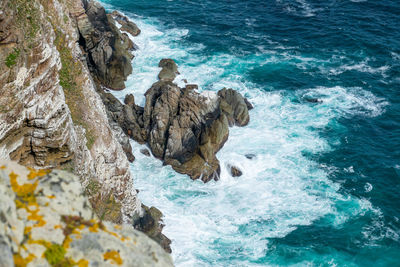 High angle view of rocks in sea