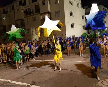 Crowd standing on street in city