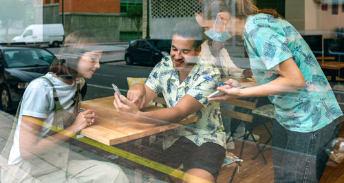 Waiter taking order of man and woman