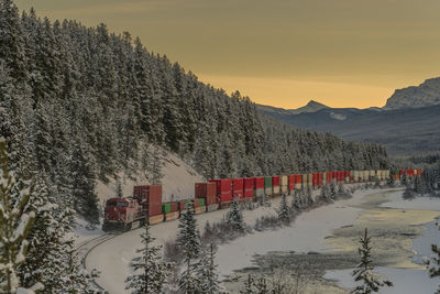 Scenic view of snowcapped mountains against sky during sunset