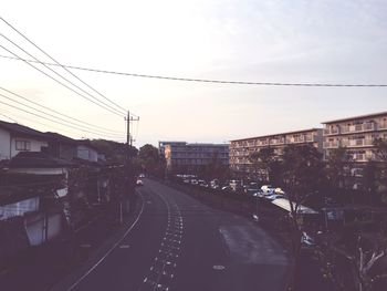 View of railroad tracks in city against sky