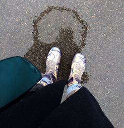 Low section of person standing on tiled floor