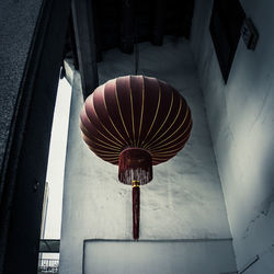Low angle view of electric lamp hanging on ceiling