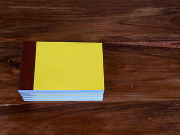 Directly above shot of yellow paper on table