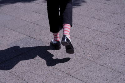 Low section of person walking on footpath