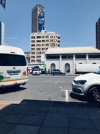 Cars on road against buildings in city