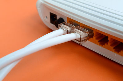 Close-up of router and cable on table