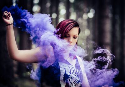 Portrait of beautiful woman holding purple outdoors