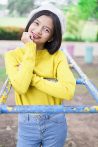 Smiling young woman standing outdoors