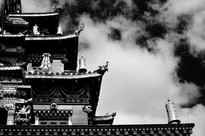 Low angle view of buddhist temple against cloudy sky