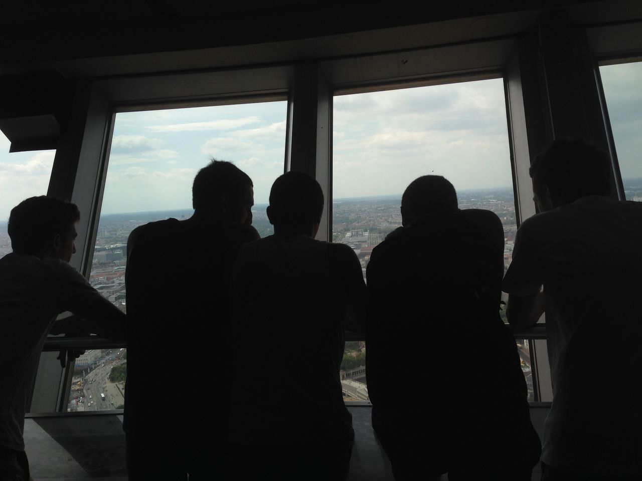 indoors, men, silhouette, window, person, lifestyles, sky, glass - material, leisure activity, standing, built structure, medium group of people, architecture, rear view, travel, large group of people, transparent, togetherness, cloud - sky