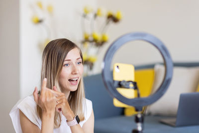 Female influencer making tutorial at home