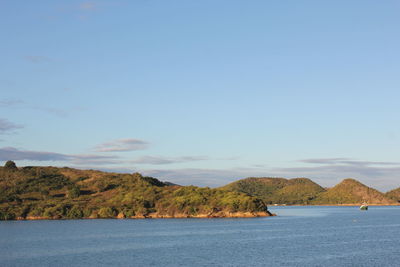 Scenic view of sea and mountains against sky