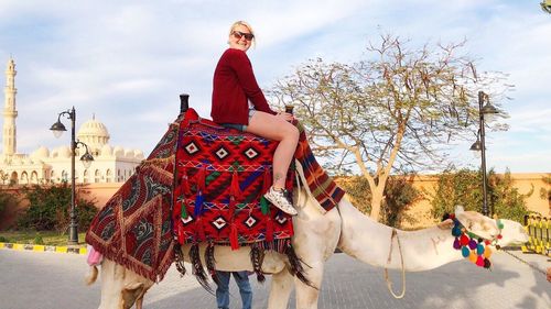 Portrait of woman riding horse in city