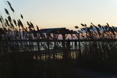 Silhouette bridge against sky during sunset