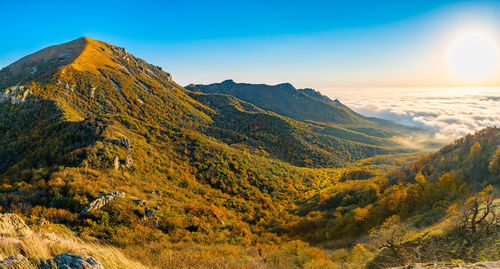 Scenic view of mountains against clear sky during sunset