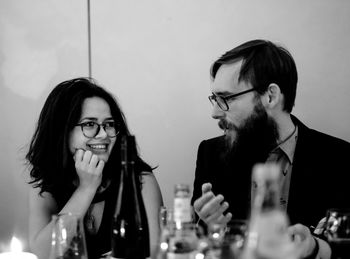 Close-up of smiling friends sitting at restaurant