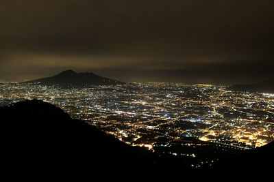 High angle view of illuminated buildings in city at night