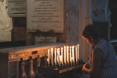 Midsection of woman at illuminated temple