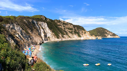 Scenic view of sea and mountains against sky