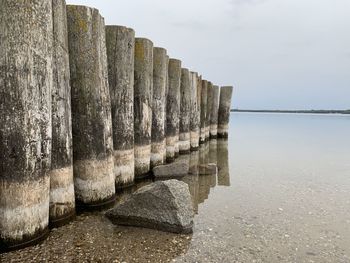 Wooden posts on beach