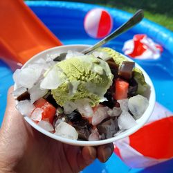 Close-up of hand holding ice cream