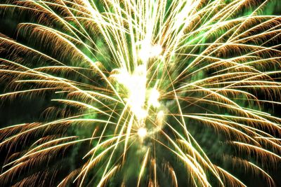 Low angle view of firework display at night