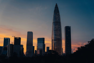 Low angle view of buildings against sky during sunset