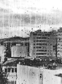 Buildings seen through wet window in rainy season