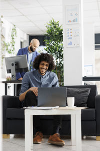 Businesswoman using laptop at office