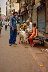 People with dog in city