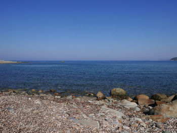 Scenic view of sea against clear blue sky