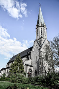 Low angle view of bell tower against sky
