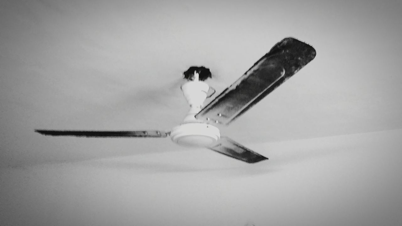 CLOSE-UP OF AIRPLANE AGAINST GRAY BACKGROUND