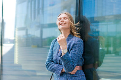 Confident successful smiling business woman entrepreneur in suit standing