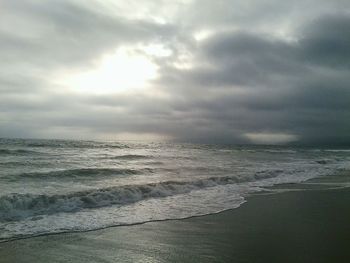 Scenic view of sea against cloudy sky