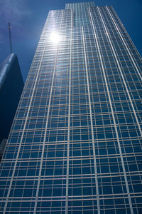 Low angle view of modern building against blue sky