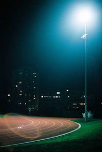 Illuminated street lights against clear sky at night