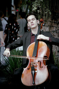 Full length of young man playing in music concert