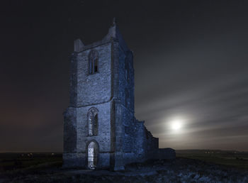 Low angle view of old building against sky at night