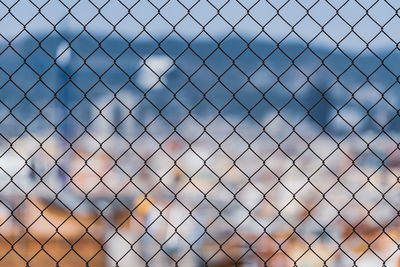 Full frame shot of chainlink fence against sky