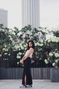 Full length portrait of woman standing in city
