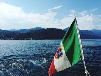 Scenic view of flag on mountain against sky