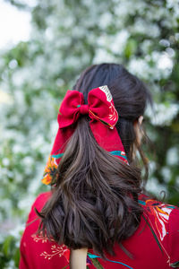 Rear view of woman with red umbrella