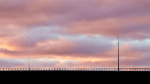 Beautiful evening sky. colorful blue, pink and violet sky and silhouettes of lanterns on bridge.