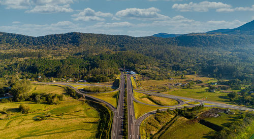 High angle view of road amidst trees against sky